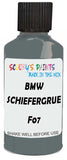 Detail brush applying Green Solid to a small door scratch on an Bmw 7-Series, clean OEM finish