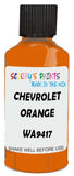 Detail brush applying Orange Solid to a small door scratch on an Chevrolet T-Series, clean OEM finish