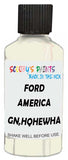 Detail brush applying White Solid to a small door scratch on an Ford F-150, clean OEM finish