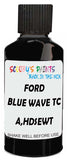 Detail brush applying Black Solid to a small door scratch on an Ford Fiesta, clean OEM finish