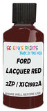 Detail brush applying Red Solid to a small door scratch on an Ford Osi, clean OEM finish