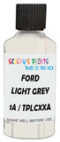 Detail brush applying White Solid to a small door scratch on an Ford Custom, clean OEM finish