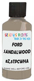 Detail brush applying Beige Solid to a small door scratch on an Ford Taurus, clean OEM finish