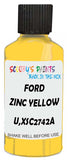 Detail brush applying Yellow Solid to a small door scratch on an Ford Escort, clean OEM finish