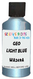 Detail brush applying Blue Metallic to a small door scratch on an Geo Metro, clean OEM finish