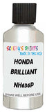 Detail brush applying White Metallic to a small door scratch on an Honda Civic Hybrid, clean OEM finish