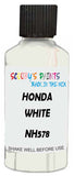 Detail brush applying White Solid to a small door scratch on an Honda Fit, clean OEM finish